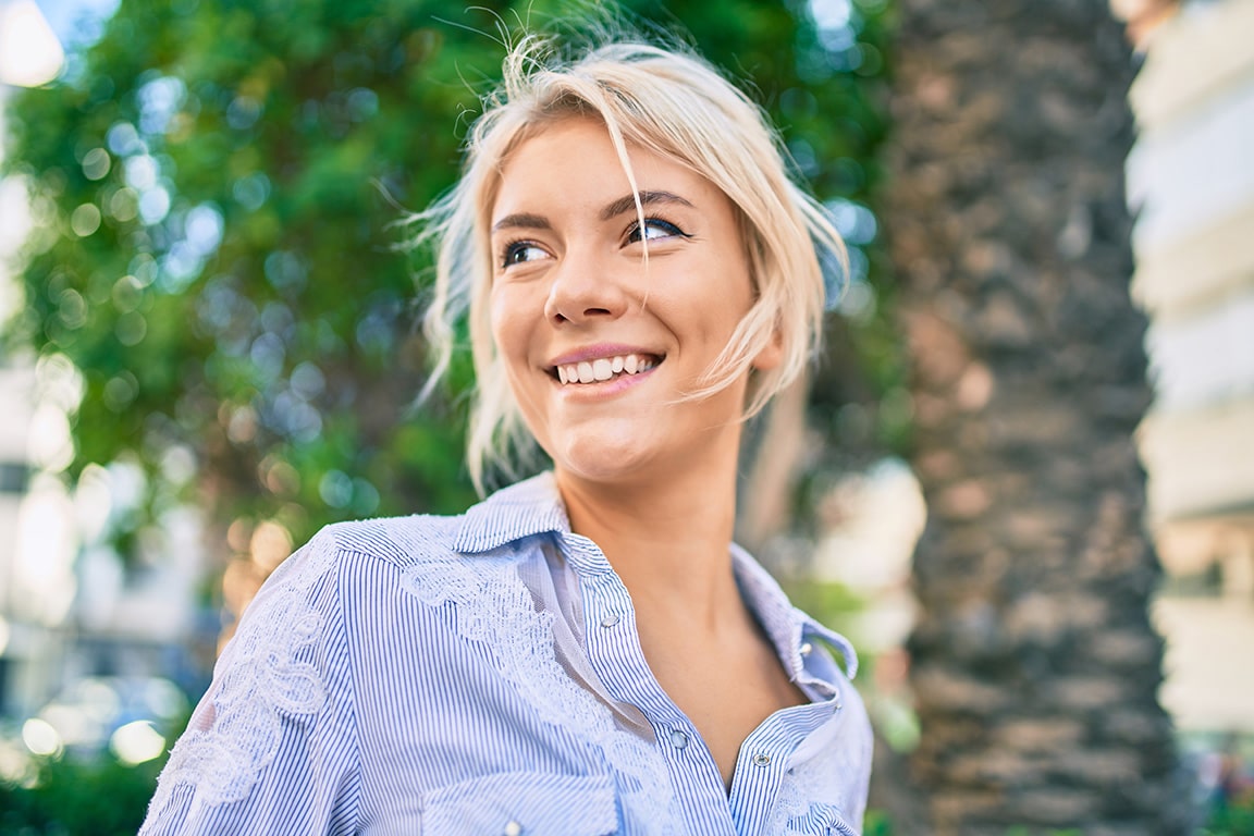 Young female smiling while looking left.