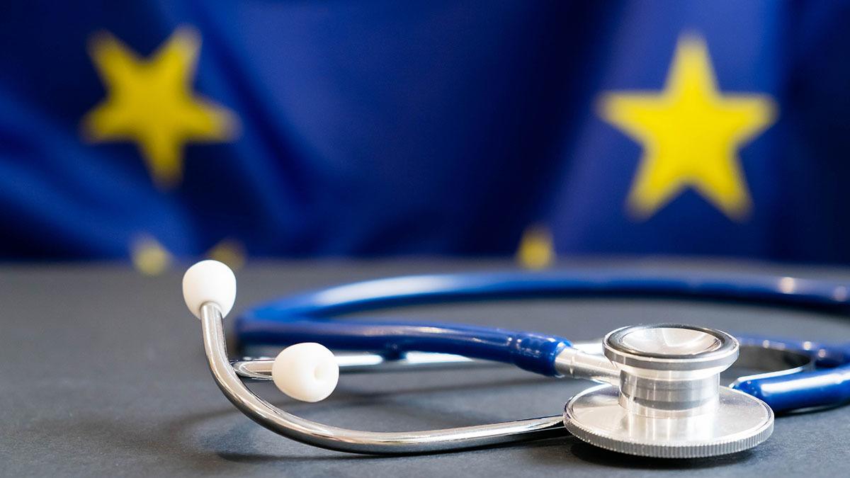 Doctor's stethoscope in front of a European Union flag