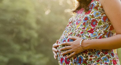 Pregnant woman holding her midsection