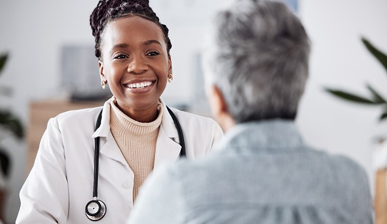 Smiling doctor speaking to a patient